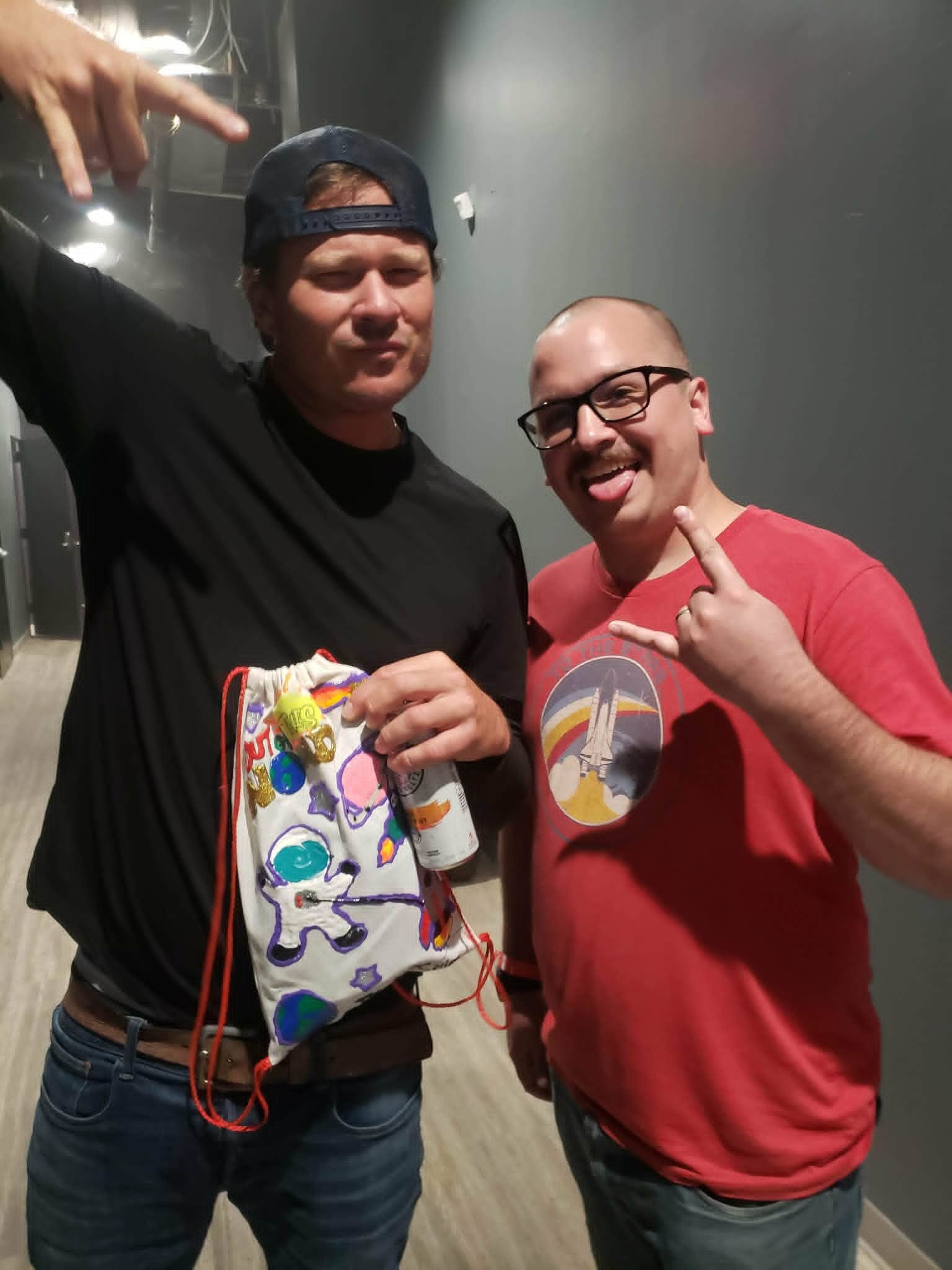 Kyle Knopp with Tom DeLonge at an Angels & Airwaves show